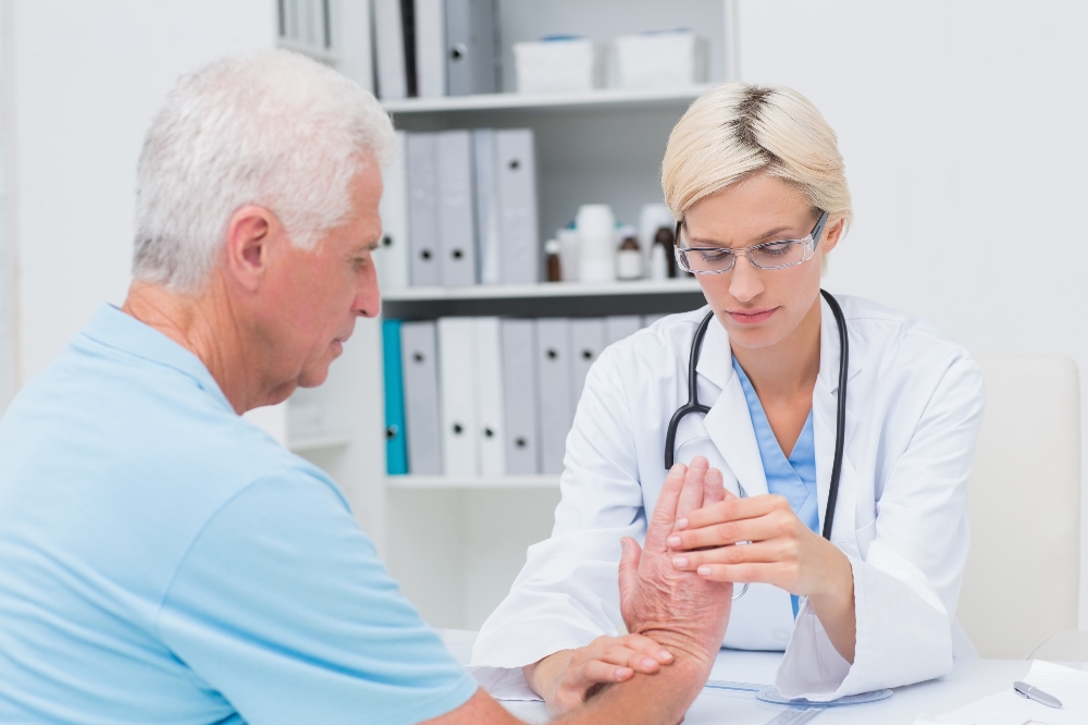 Doctor examines patient's wrist and hand.